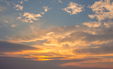 Blue, beautiful sky with white, orange, puffy clouds