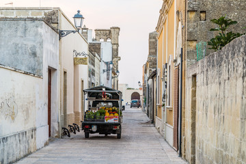 three-wheeled vehicle in street of fortified citadel