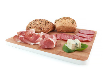 cereal bread, speck, salami and gorgonzola on white background