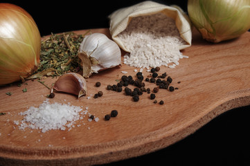 Fototapeta na wymiar Still life of spices and rice on a black background