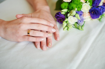 Obraz na płótnie Canvas Female hand with wedding rings over tablecloth background