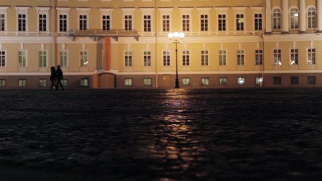 View of Palace square in Saint Petersburg in night. Silhouettes of couples.