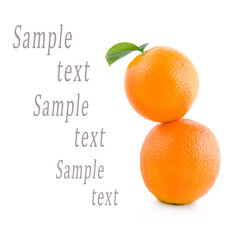 two oranges stand on each other on a white background