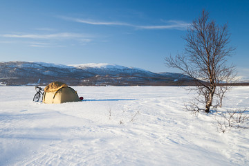 Winterzelten auf einem zugefrorenen See in Schweden