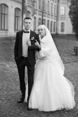 Bride and groom embrace on a walk in the countryside for a walk