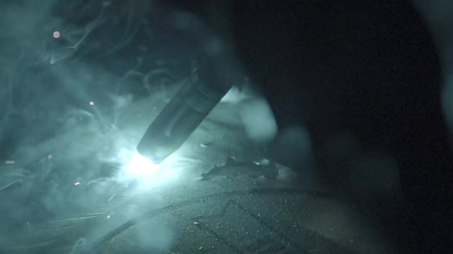 Welding at auto mechanics in slow motion