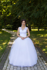 Fototapeta na wymiar Bride with beautiful eyes at a wedding a walk in the woods