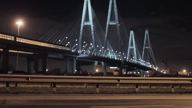 View of huge motorway bridge in night city focus out.  Illumination lights.