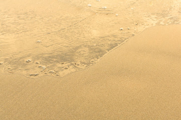 Fototapeta na wymiar Sand beach with the soft wave.