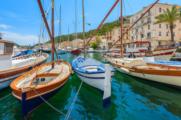 Traditional fishing boats in Bonifacio port on sunny summer day, Corsica island, France