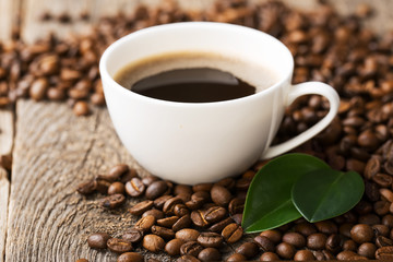ground coffee in scoop and coffee beans on a wooden background,