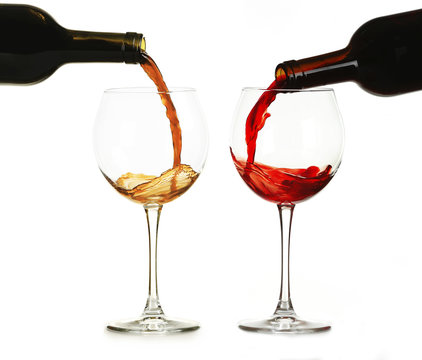 White and red wine pouring in glasses, isolated on white