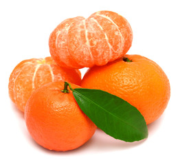 Mandarin with leaf and slices of peeled tangerine