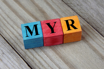 MYR (Malaysian Ringgit) sign on colorful wooden cubes