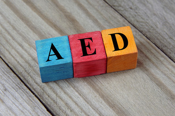 AED (Emirati Dirham) sign on colorful wooden cubes