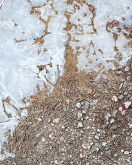 Frozen puddle and dirt road close-up