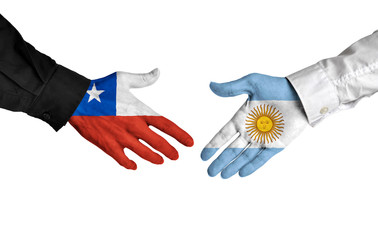 Chile and Argentina leaders shaking hands on a deal agreement