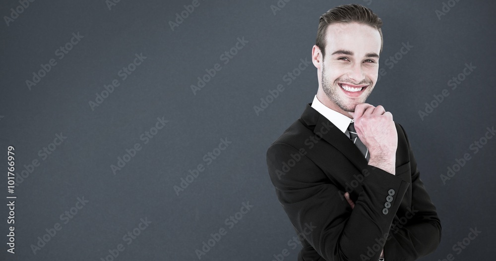 Poster Composite image of happy businessman standing with hand on chin