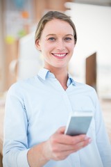 Fototapeta na wymiar Composite image of businesswoman using her mobile phone