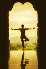 Silhouette of a beautiful Yoga woman in the morning - vintage st