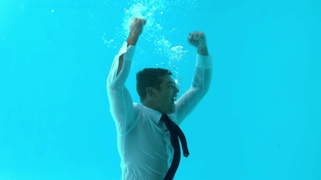 Businessman diving into water