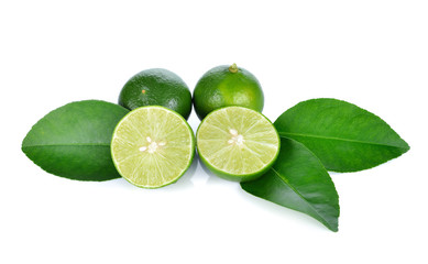 Limes with slices and leaves isolated on white background