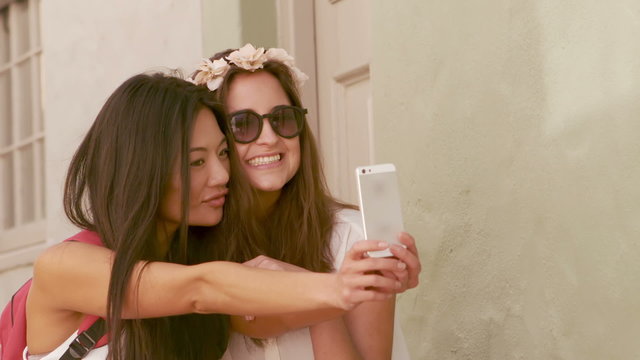 Smiling hipster friends taking selfie together