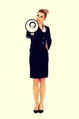 Beautiful businesswoman shouting with megaphone