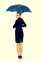 Blonde businesswoman holding an umbrella