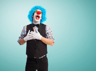 portrait of a clown doing a love gesture
