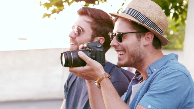 Hipster friends taking pictures with an old camera