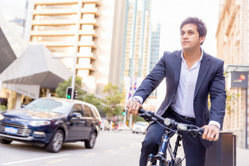 Successful businessman riding bicycle