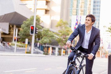 Naklejka na ściany i meble Successful businessman riding bicycle