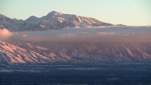 The Wasatch mountain range over looks the Salt Lake City valley at sunset.