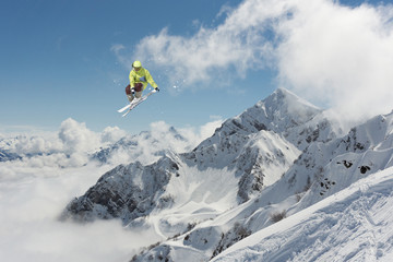 Naklejka na ściany i meble Flying skier on mountains. Extreme ski sport.