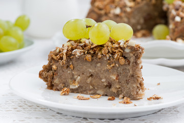 piece of delicious nut pie with grapes, closeup