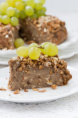 piece of delicious nut pie with grapes, closeup vertical