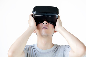 Asian man wearing VR goggle and immersing himself in VR multimedia