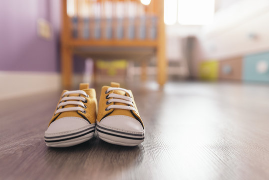 Pair Of Newborn Shoes In Baby Room