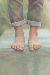 Young handsome man posing bare feet