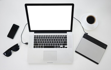 Top view of modern laptop and gadgets on a table