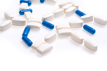 White and blue medical pills for treating diseases on a white background