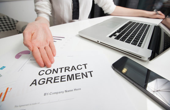 Business woman handing over a contract for signature offering