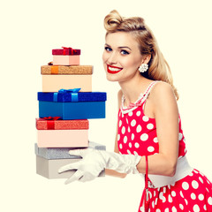 woman in pin-up style red dress with gift boxes