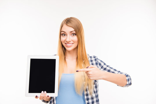 Pretty young girl pointing on screen of tablet