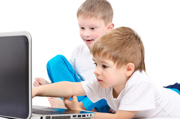 Two children looking on laptop screen