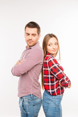 Naklejka premium Young couple in love standing back to back with crossed hands
