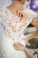 bride getting dressed on her wedding day