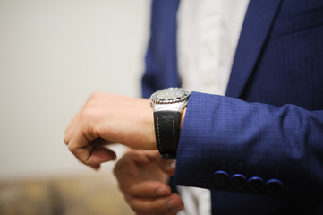 a groom is Getting Ready and showing watches