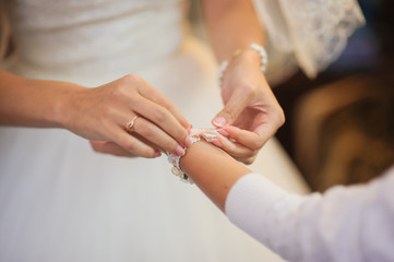 bride getting bracelet dressed